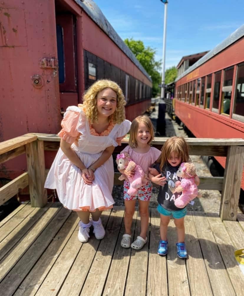 Goldilocks with two kids holding teddy bears